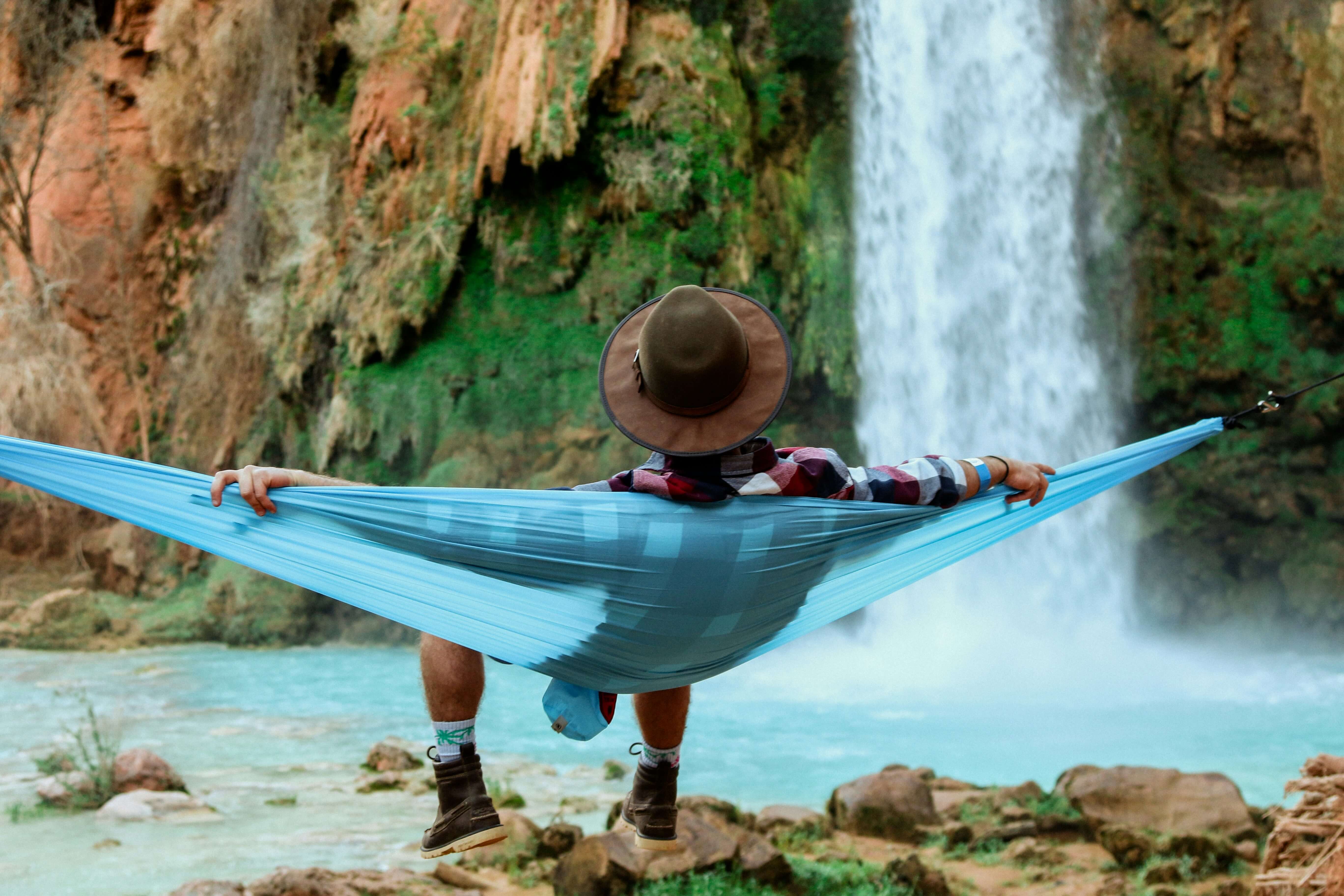 man relaxing on a hammock in nature 