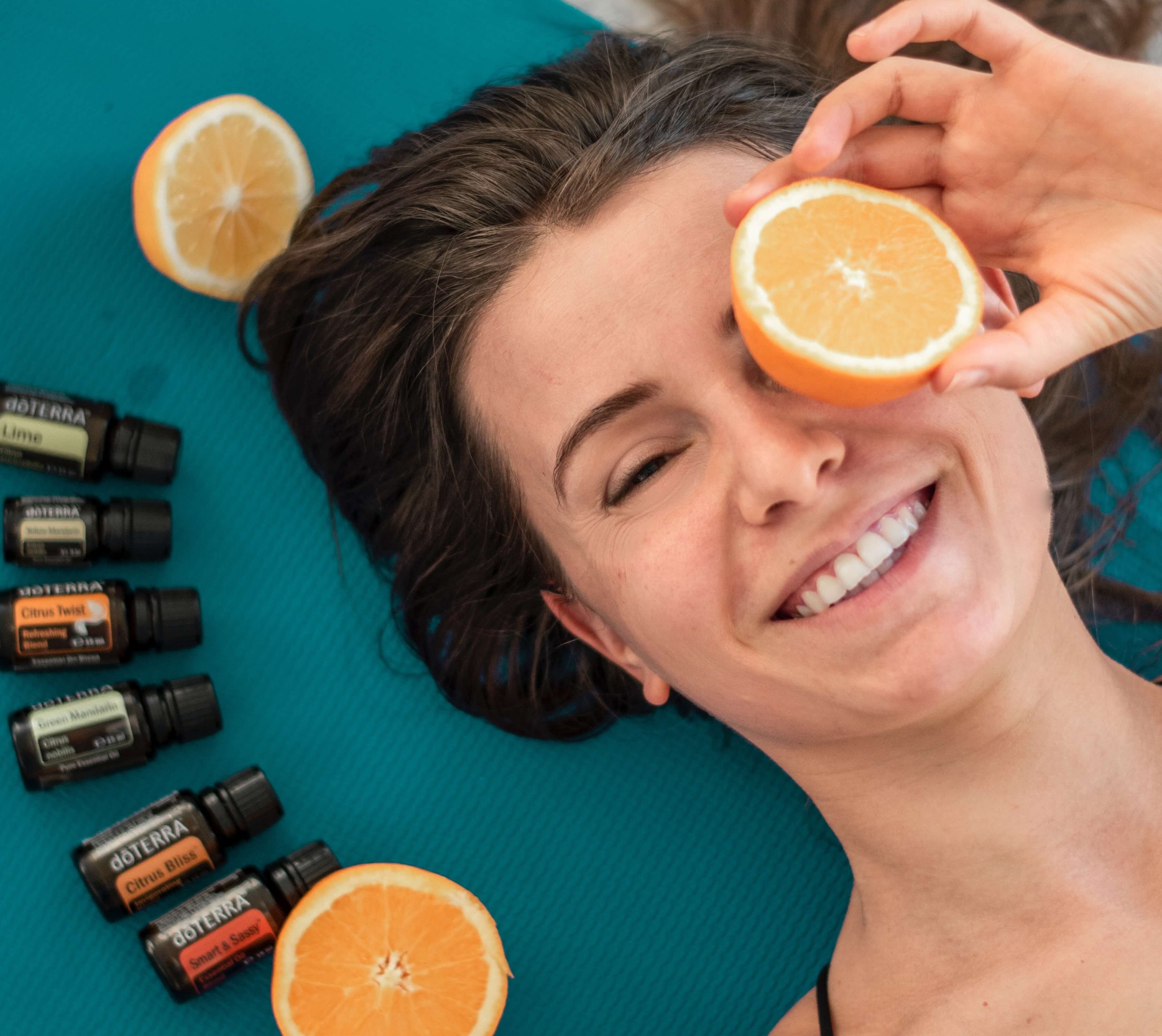 woman surrounded by essential oils 